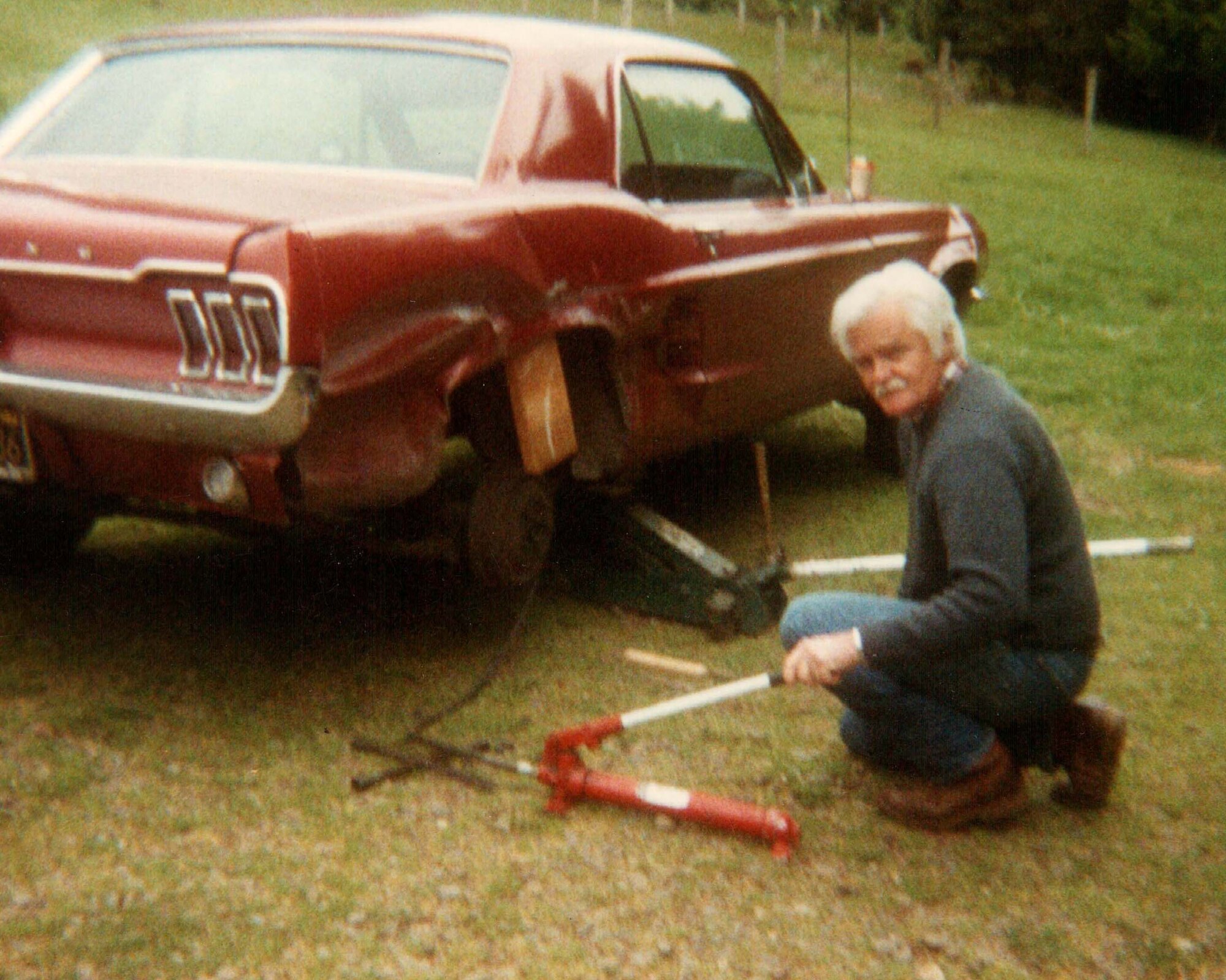 George G. Shaw poses for a photo while repairing the courter panel on a 1967 Ford mustang, 1988, at his home in Arcata, Calif. Shaw built the mustang for his daughter as her first car, and the vehicle was later passed on to his granddaughter. (Courtesy photo)