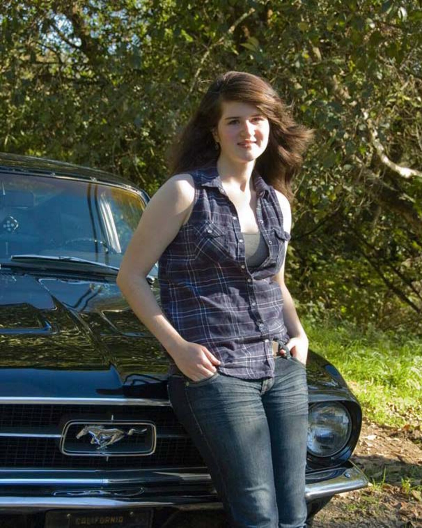 Jenna K. Caldwell poses for a photo in front of a Ford mustang, Nov. 2013, at her home in Arcata, Calif. The mustang, a 1967 fastback, belonged to her grandfather and a similar vehicle to her first car, a 1967 Ford mustang coupe. (Courtesy photo) 