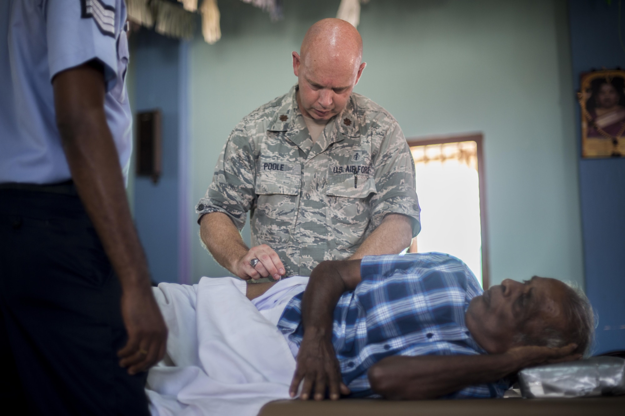 U.S. Air Force Maj. David Poole, 35th Medical Operations Squadron physical therapy flight chief, dry needles a patient’s hip during Pacific Angel (PACANGEL) 16-3 in Jaffna, Sri Lanka, Aug. 16, 2016. PACANGEL 16 includes general health, dental, optometry, pediatrics, and engineering programs as well as various subject-matter exchanges. (U.S. Air Force photo by Senior Airman Brittany A. Chase)