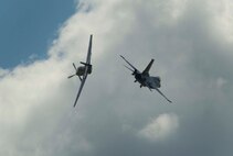 A P-51 Mustang and an F-16 Fighting Falcon cross paths during Northern Neighbors Day at Minot Air Force Base, N.D., Aug. 13, 2016. The two aircraft performed a Heritage Flight together during the show. (U.S. Air Force photo/Senior Airman Apryl Hall)