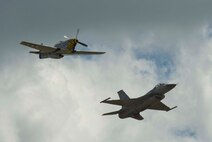 A P-51 Mustang and an F-16 Fighting Falcon fly side-by-side during Northern Neighbors Day at Minot Air Force Base, N.D., Aug. 13, 2016. The two aircraft performed a Heritage Flight together during the show. (U.S. Air Force photo/Senior Airman Apryl Hall)