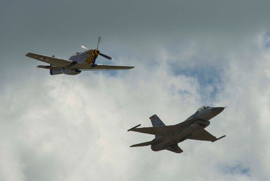 A P-51 Mustang and an F-16 Fighting Falcon fly side-by-side during Northern Neighbors Day at Minot Air Force Base, N.D., Aug. 13, 2016. The two aircraft performed a Heritage Flight together during the show. (U.S. Air Force photo/Senior Airman Apryl Hall)