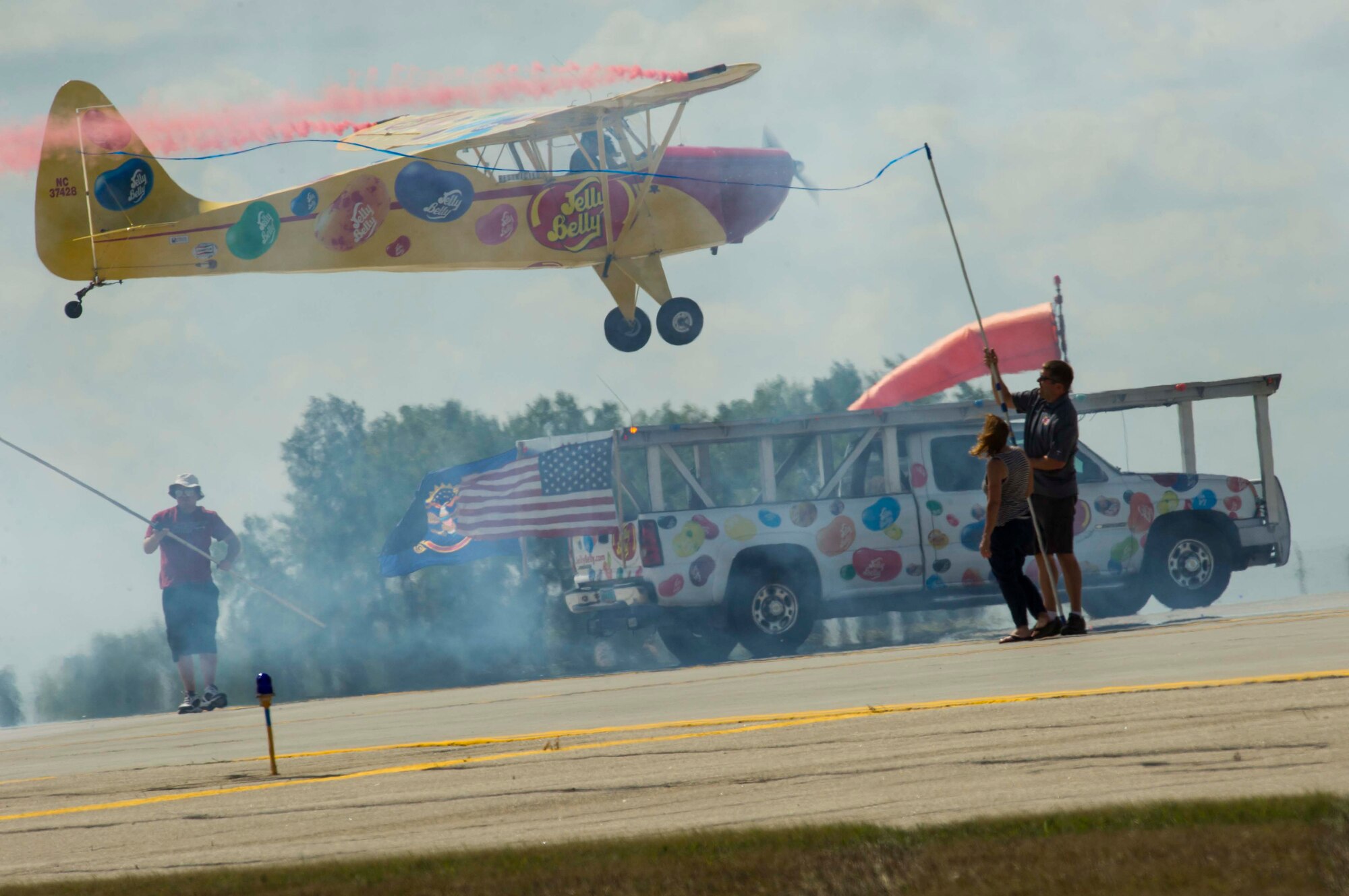 Kent Pietsch lands his aircraft on a truck during Northern Neighbors Day at Minot Air Force Base, N.D., Aug. 13, 2016. The Pietsch brothers flew several different aircraft in different demonstrations throughout the day. (U.S. Air Force photo/Senior Airman Apryl Hall)