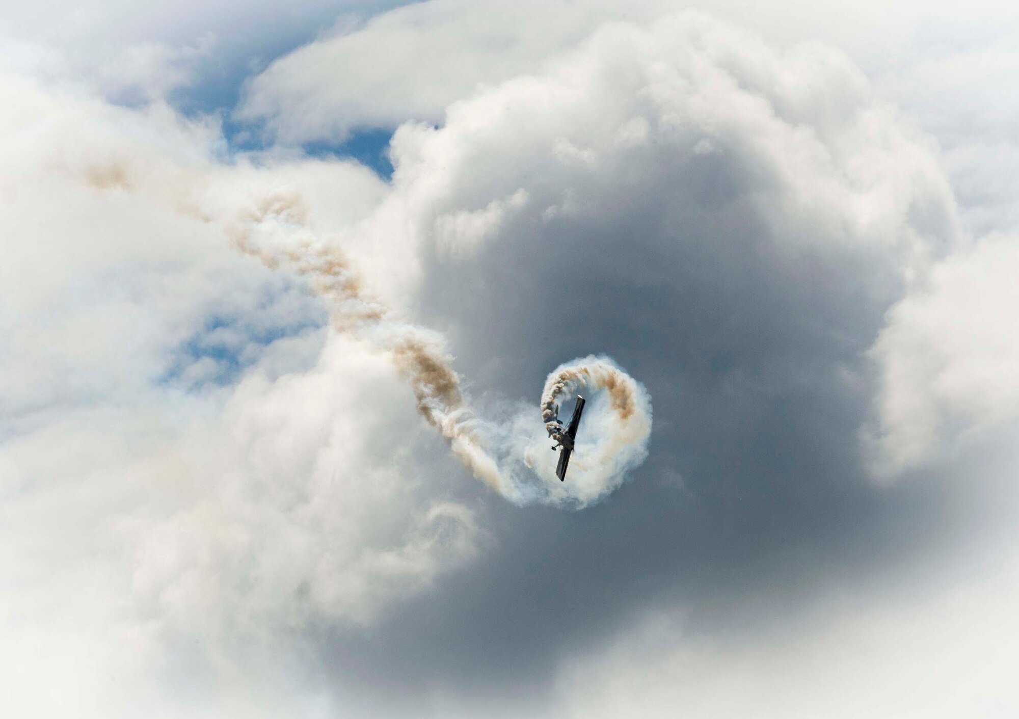 An aircraft barrels through the sky during the Northern Neighbors Day Air Show at Minot Air Force Base, N.D., Aug. 13, 2016. The air show featured demonstrations from civilian and military aircraft. (U.S. Air Force photo/Senior Airman Sahara L. Fales)