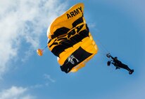 A member of the U.S. Army Golden Knights aerial demonstration team opens his parachute while preparing to land at Minot Air Force Base, N.D., during the Northern Neighbors Day Air Show on Aug. 13, 2016. The Golden Knights perform around the world at air shows, sporting events and other performances. (U.S. Air Force photo/Senior Airman Sahara L. Fales)