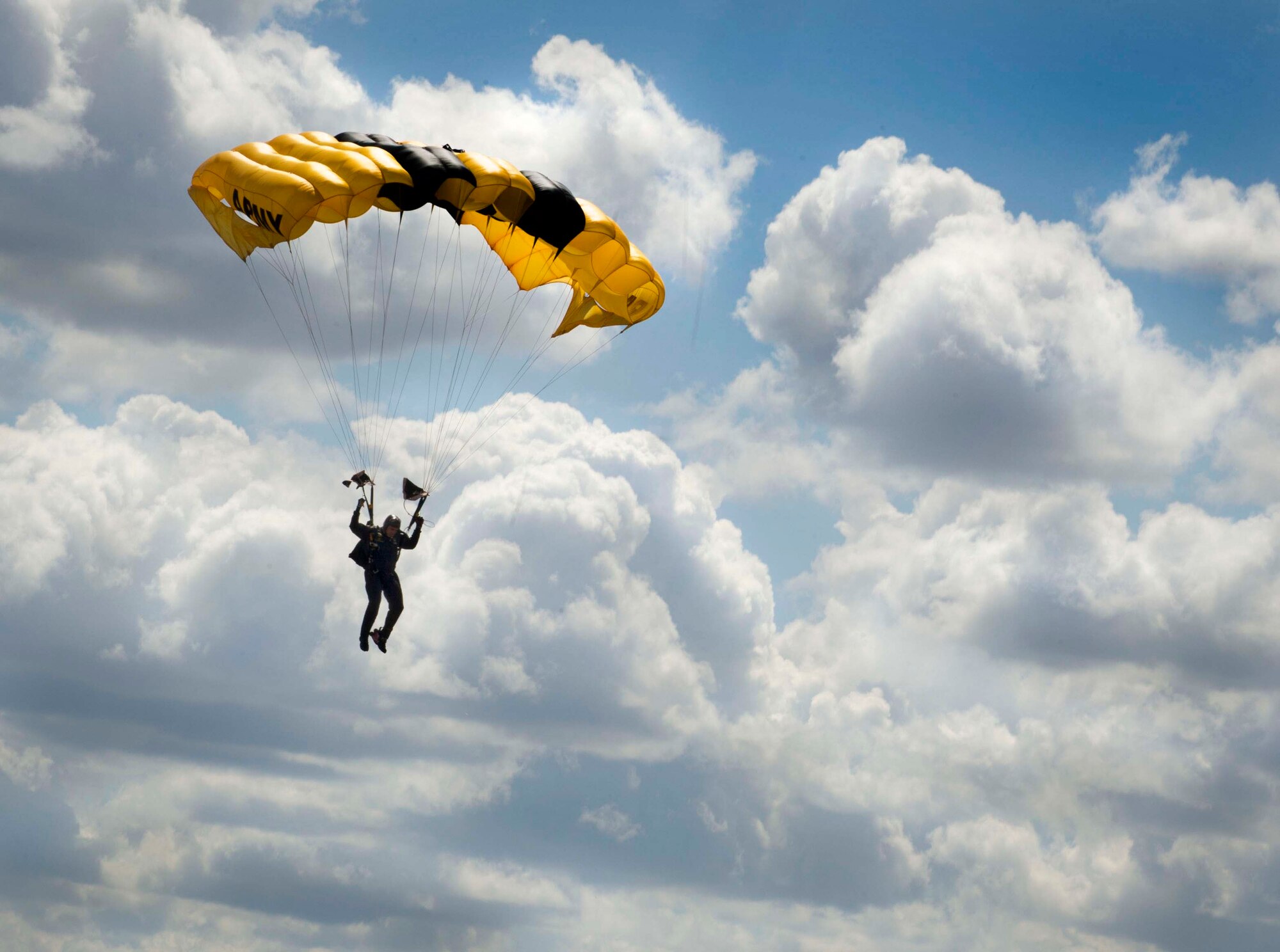 A member of the U.S. Army Golden Knights aerial demonstration team prepares to land at Minot Air Force Base, N.D., during the Northern Neighbors Day Air Show on Aug. 13, 2016. The Golden Knights performed solo and tandem jump demonstrations. (U.S. Air Force photo/Senior Airman Sahara L. Fales)