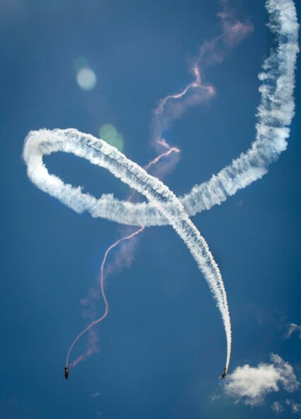 Two aircraft soar through the sky during an aerial demonstration for the Northern Neighbors Day Air Show at Minot Air Force Base, N.D., Aug. 13, 2016. Over 10,000 patrons attended the air show, which was the first Team Minot has hosted since 2009. (U.S. Air Force photo/Senior Airman Sahara L. Fales)