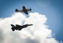 A P-51D Mustang and F-16 Fighting Falcon perform a Heritage Flight during the Northern Neighbors Day Air Show at Minot Air Force Base, N.D., Aug. 13, 2016. The two aircraft flew together to showcase how our aircraft has evolved. (U.S. Air Force photo/Senior Airman Sahara L. Fales)