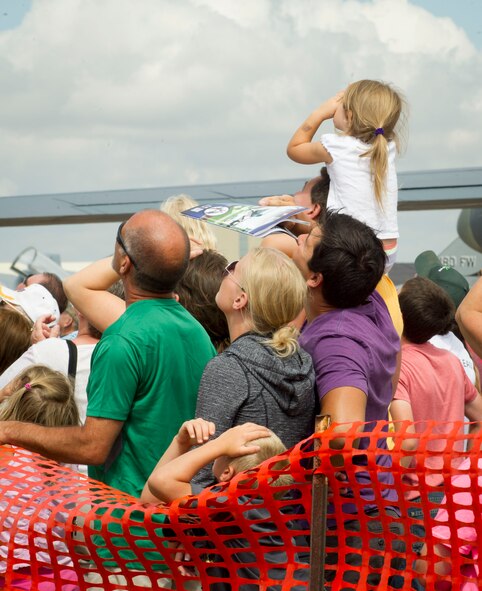 A family watches an aerial demonstration during the Northern Neighbors Day Air Show at Minot Air Force Base, N.D., Aug. 13, 2016. This was Team Minot’s first air show since 2009. (U.S. Air Force photo/Senior Airman Sahara L. Fales)