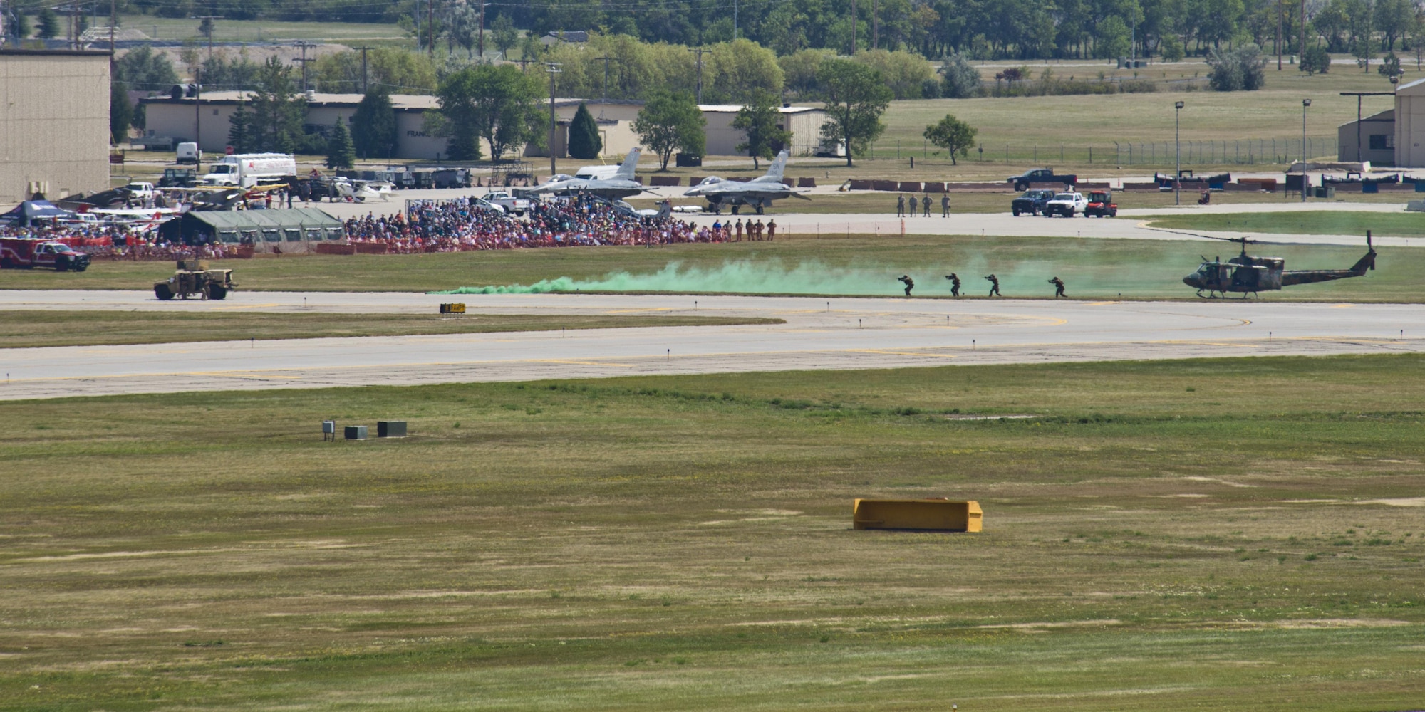 Tactical Response Force members approach a Humvee while performing a demonstration during the Northern Neighbors Day Air Show at Minot Air Force Base, N.D., Aug. 13, 2016. As part of a UH-1N insertion, TRF members demonstrated how they would provide air support to ground forces. (U.S. Air Force photo/Airman 1st Class J.T. Armstrong)