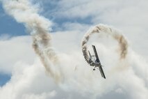 A bi-plan performs an acrobatic aerial demonstration at the Northern Neighbors Day Air Show at Minot Air Force Base, N.D., Aug. 13, 2016. NND included several aerial acts including the F-16 Fighting Falcon, bi-plane crop dusters and old World War II planes. (U.S. Air Force photo/Airman 1st Class Christian Sullivan)