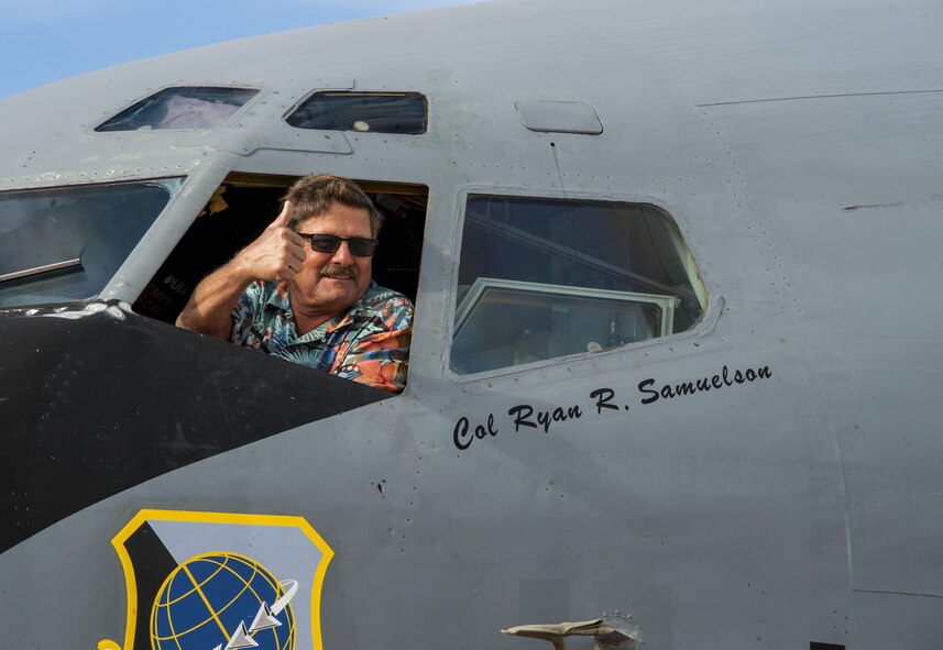 A spectator poses for a picture during Northern Neighbors Day Air Show at Minot Air Force Base, N.D., Aug. 13, 2016. Spectators were allowed to take tours inside of different aircraft before the air show. (U.S. Air Force photo/Airman 1st Class Christian Sullivan)