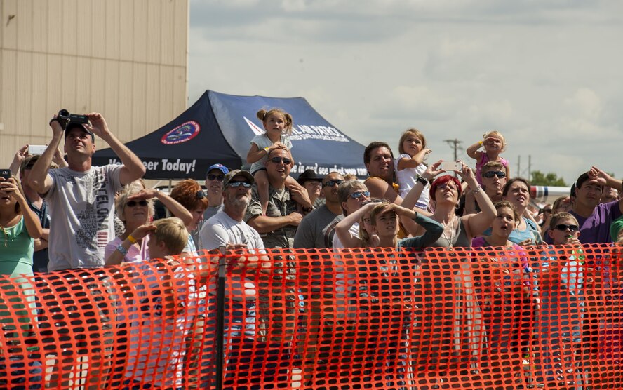 Spectators watch an F-16 Fighting Falcon demo during the Northern Neighbors Day Air Show at Minot Air Force Base, N.D., Aug. 13, 2016. NND included several aerial acts including the F-16, bi-plane crop dusters and old World War II planes. (U.S. Air Force photo/Airman 1st Class Christian Sullivan)