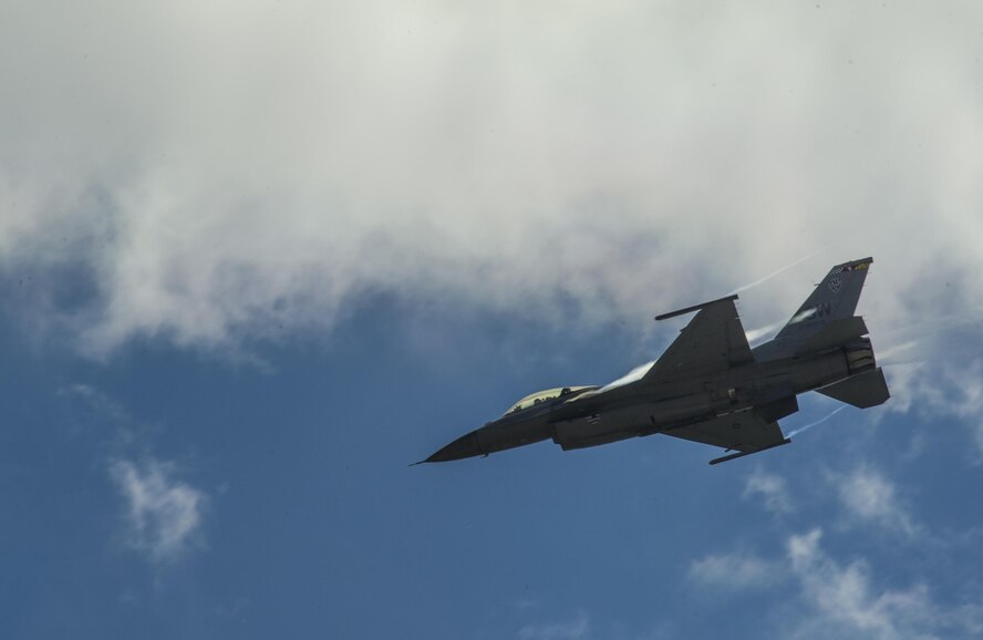 An F-16 Fighting Falcon performs a demonstration at the Northern Neighbors Day Air Show at Minot Air Force Base, N.D., Aug. 13, 2016. NND included several aerial acts including the F-16, bi-plane crop dusters and old World War II planes. (U.S. Air Force photo/Airman 1st Class Christian Sullivan)