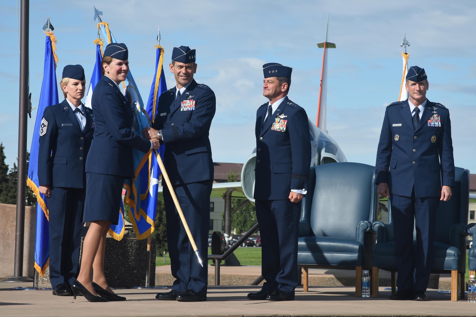 U.S. Air Force Gen. Lori Robinson, North American Aerospace Defense Command and U.S. Northern Command commander gives command of Alaskan NORAD Region and Alaskan Command to U.S. Air Force Lt. Gen. Kenneth Wilsbach during a change of command ceremony Aug. 16 at Joint Base Elmendorf-Richardson, Alaska.  Wilsbach also assumed command of 11th Air Force from Gen. Terrence O'Shaughnessy, Pacific Air Forces commander. Outgoing commander Lt. Gen. Russell Handy retired after more than 30 years of service and relinquished command to Wilsbach.