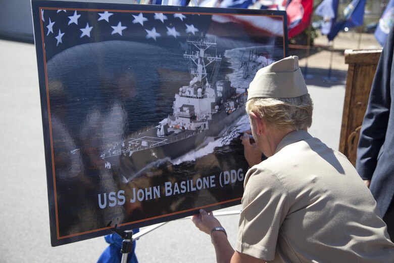 U.S. Navy Vice Adm. Nora W. Tyson, Commander, U.S. 3rd Fleet signs the graphic of the USS John Basilone after the ship naming ceremony for the USS John Basilone (DDG-122) on Camp Pendleton, Calif., August 16, 2016. (U.S. Marine Corps photo by Cpl. Tyler S. Dietrich)