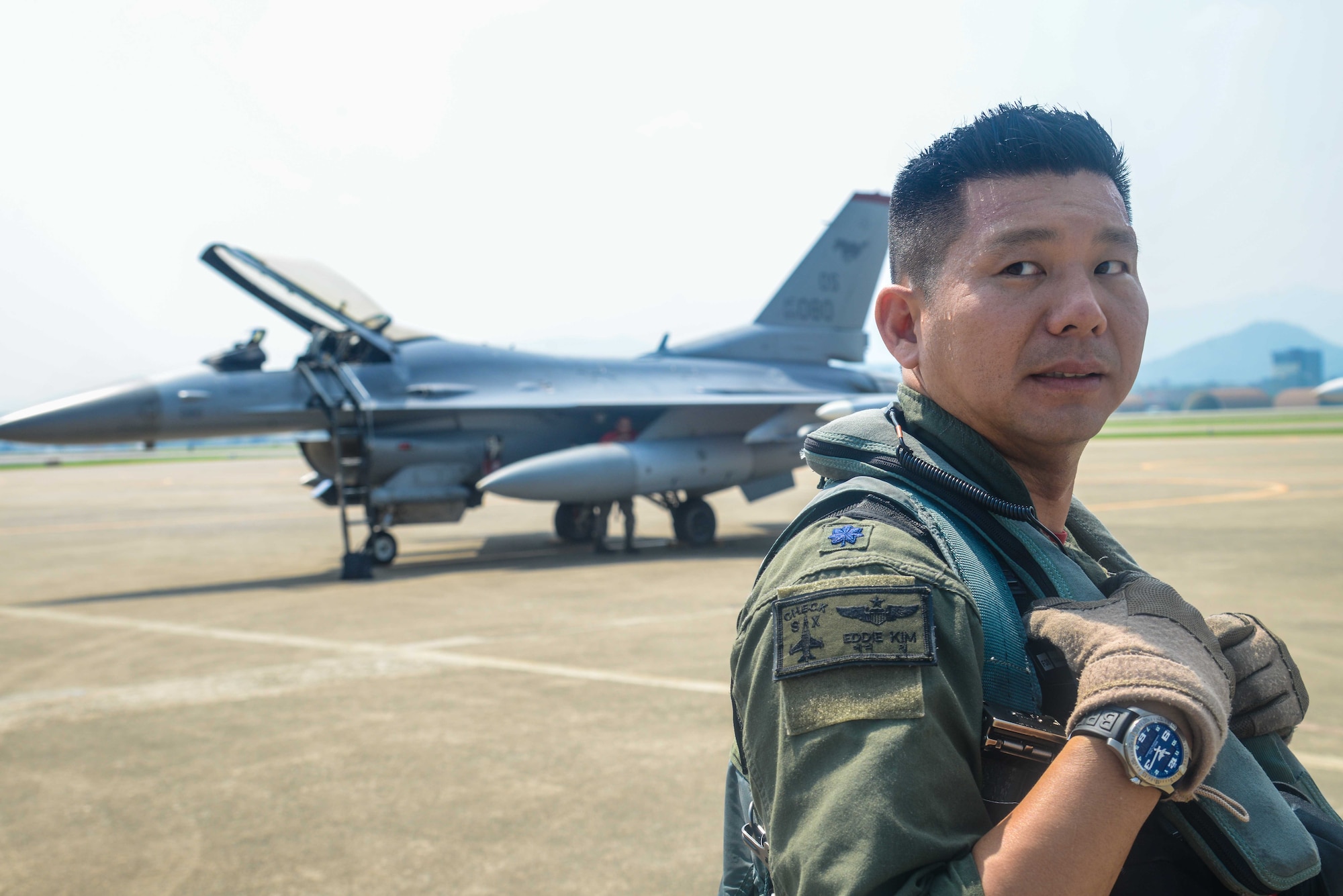 Lt. Col. Edward Kim, 36th Fighter Squadron F-16 Fighting Falcon pilot, prepares for a flying training mission during Buddy Wing 16-7 at Daegu Air Base, Republic of Korea, Aug. 12, 2016. Buddy Wing is designed to introduce and review tactics, exchange ideas and improve the interoperability between U.S. and ROK air force pilots, maintainers and support personnel. (U.S. Air Force photo by Senior Airman Dillian Bamman)
