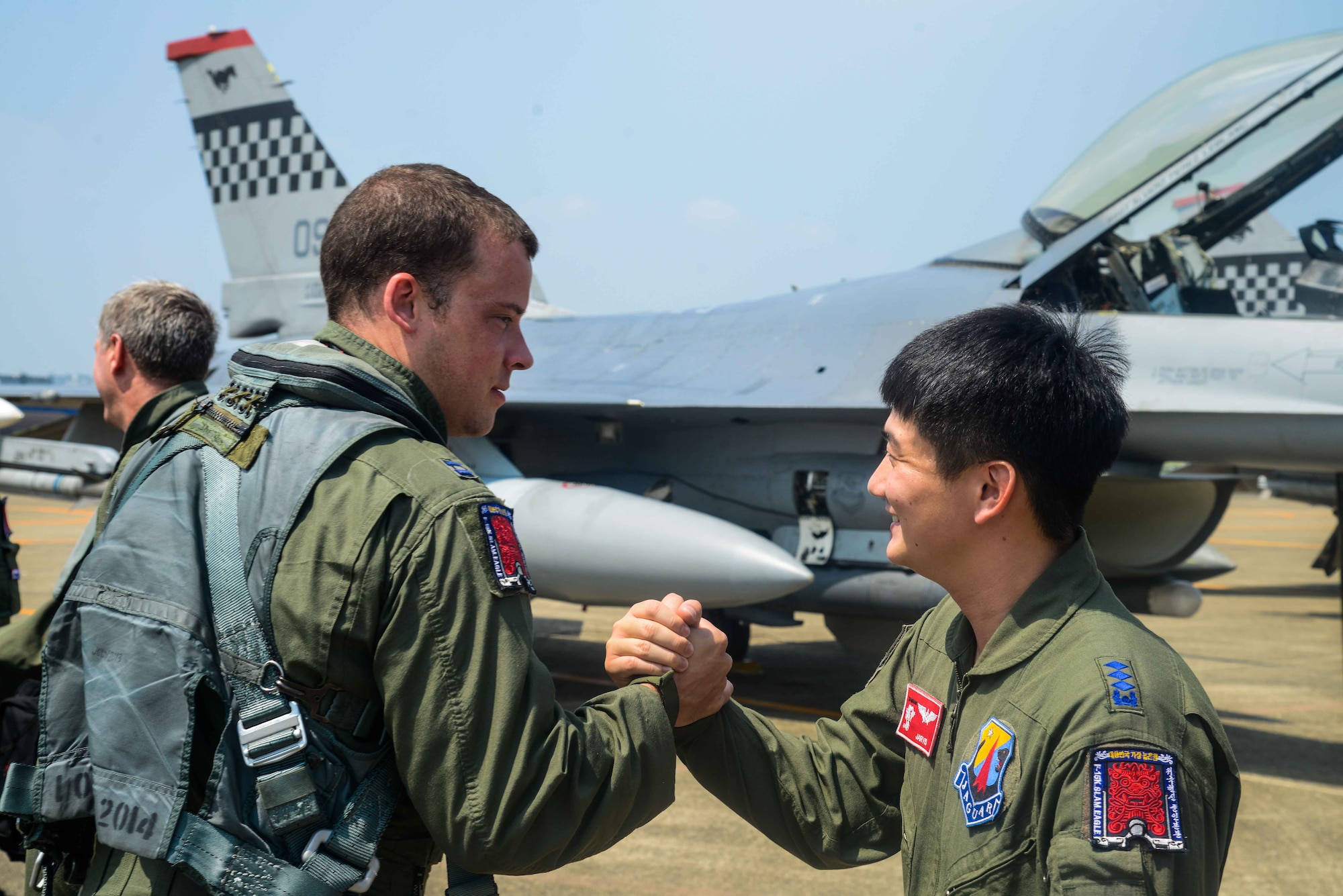 Capt. Ryan Pebler, 36th Fighter Squadron F-16 Fighting Falcon pilot, shakes hands with Republic of Korea air force Capt. Chon, Hun Min, 11th Fighter Wing F-15K Slam Eagle pilot, before takeoff during Buddy Wing 16-7 at Daegu Air Base, ROK, Aug. 12, 2016. In October, both Pebler and Chon will be participating in RED FLAG-Alaska, a Pacific Air Forces exercise that provides joint offensive counter-air, interdiction, close air support and large force employment training in a simulated combat environment. (U.S. Air Force photo by Senior Airman Dillian Bamman)