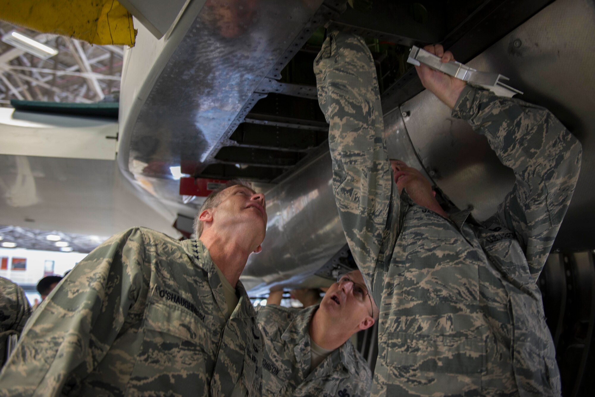 U.S. Air Force Gen. Terrence J. O’Shaughnessy, Pacific Air Forces commander, and Chief Master Sgt. Harold Hutchison, PACAF command chief, observe F-15 Eagle maintenance with Master Sgt. Logan Jackson, 18th Equipment Maintenance Squadron fabrication flight structural maintenance section chief at Kadena Air Base, Japan, Aug. 11, 2016. Jackson and the fabrication flight machine specific parts for the F-15 Eagle to keep them mission ready. (U.S. Air Force photo by Senior Airman Omari Bernard)