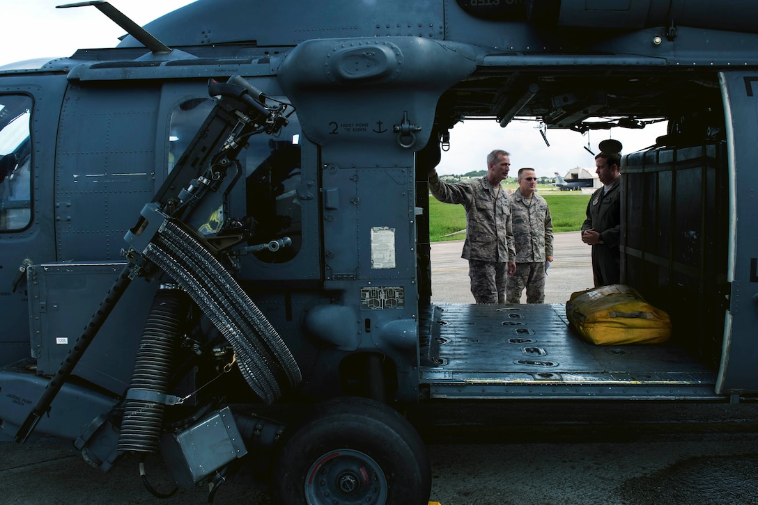 U.S. Air Force Gen. Terrence J. O’Shaughnessy, Pacific Air Forces commander, and Chief Master Sgt. Harold Hutchison, Pacific Air Forces command chief, receive a tour of an HH-60G Pavehawk at the 33rd Rescue Squadron at Kadena Air Base, Japan, Aug. 11, 2016. O’Shaughnessy received a mission overview of the rescue squadron’s challenges and capabilities operating in the Indo-Asia Pacific Theater. (U.S. Air Force photo by Senior Airman Omari Bernard)