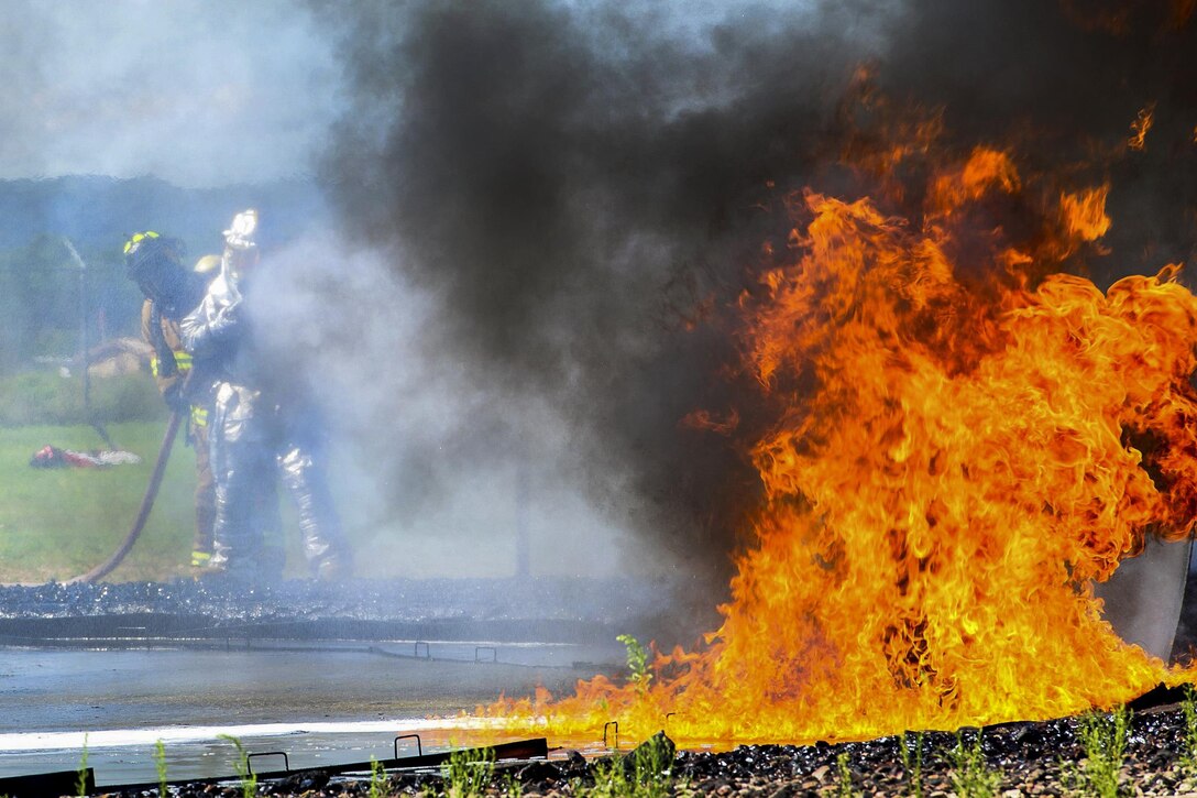 Air Force firefighters extinguish a jet fuel fire in a burn pit during live-fire training as part of Exercise Patriot Warrior 2016 at Fort McCoy Airport, Wis., Aug. 8, 2016. Air Force photo by Airman 1st Class Christopher Dyer