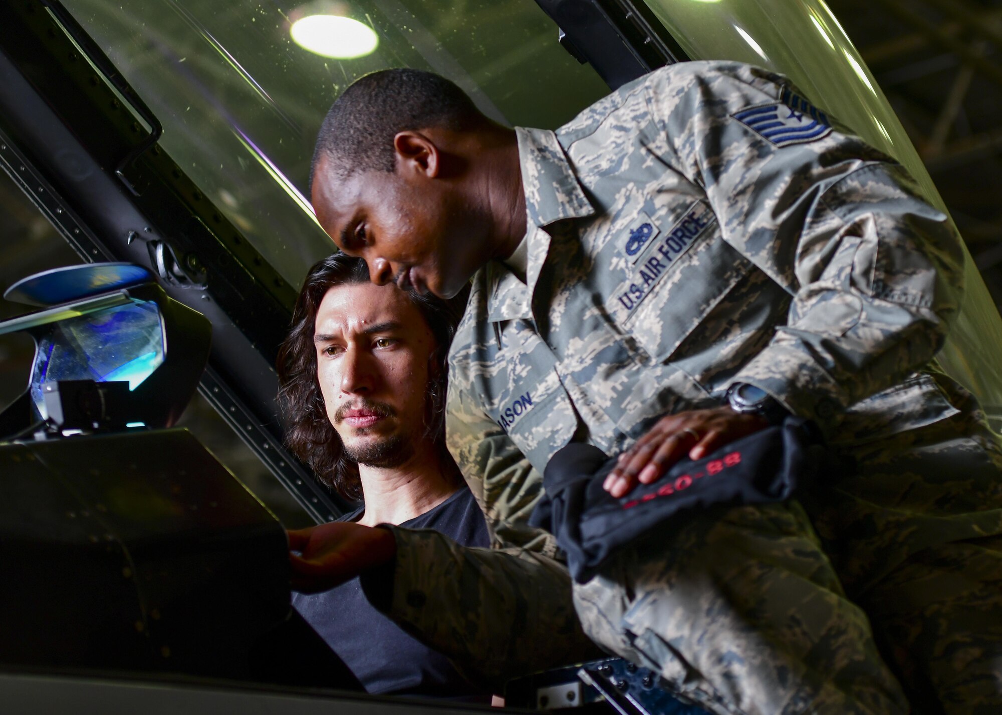 Tech. Sgt. Antonio Mason, 51st Aircraft Maintenance Squadron crew chief, explains F-16 Fighting Falcon controls to actor Adam Driver at Osan Air Base, Republic of Korea, Aug. 13, 2016. Driver and several other actors visited base and learned about the Team Osan mission before performing a reading of the play “Lobby Hero” here. (U.S. Air Force photo by Senior Airman Victor J. Caputo/Released)