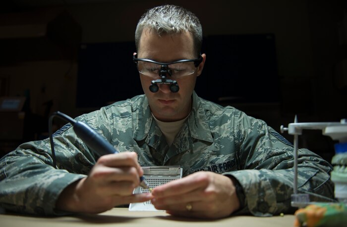 Tech. Sgt. Louis Lough, 628th Medical Group noncommissioned officer in charge of the dental laboratory, works on shaping a bridge August 9, 2016, at Joint Base Charleston, S.C. Lough entered the Air Force in 2005 with no college education. He completed undergraduate and graduate degrees, and then earned a Doctorate of Business Administration while serving on active duty. (U.S. Air Force photo/Airman 1st Class Kevin West)