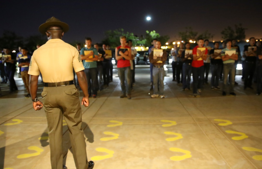 A senior drill instructor from Receiving Company, Support Battalion, welcomes new recruits to the depot during receiving at Marine Corps Recruit Depot San Diego, Aug. 15. Recruits are initially taught the position of attention as well as that they will now eat, sleep and train as a team. Annually, more than 17,000 males recruited from the Western Recruiting Region are trained at MCRD San Diego. Hotel Company is scheduled to graduate Nov. 9.