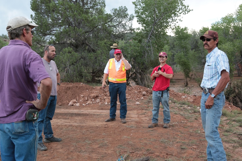 U.S. Army Corps of Engineers Los Angeles District employees Reuben Sasaki (red shirt), hydrologic engineer, and Jim Moye (red cap), senior construction representative, led a site survey for members of the construction team in Cedar Creek, Arizona, Aug. 15. The group toured areas where potential flood and debris flows could threaten lives and structures. The White Mountain Apache Tribe was affected by the Cedar Creek Fire which burned approximately 46,000 acres on their reservation and negatively impacted many of the tribal/non-tribal communities in the area. The National Weather Service forecasts include the potential for substantial flows in Cedar Creek resulting from thunderstorms in this region.