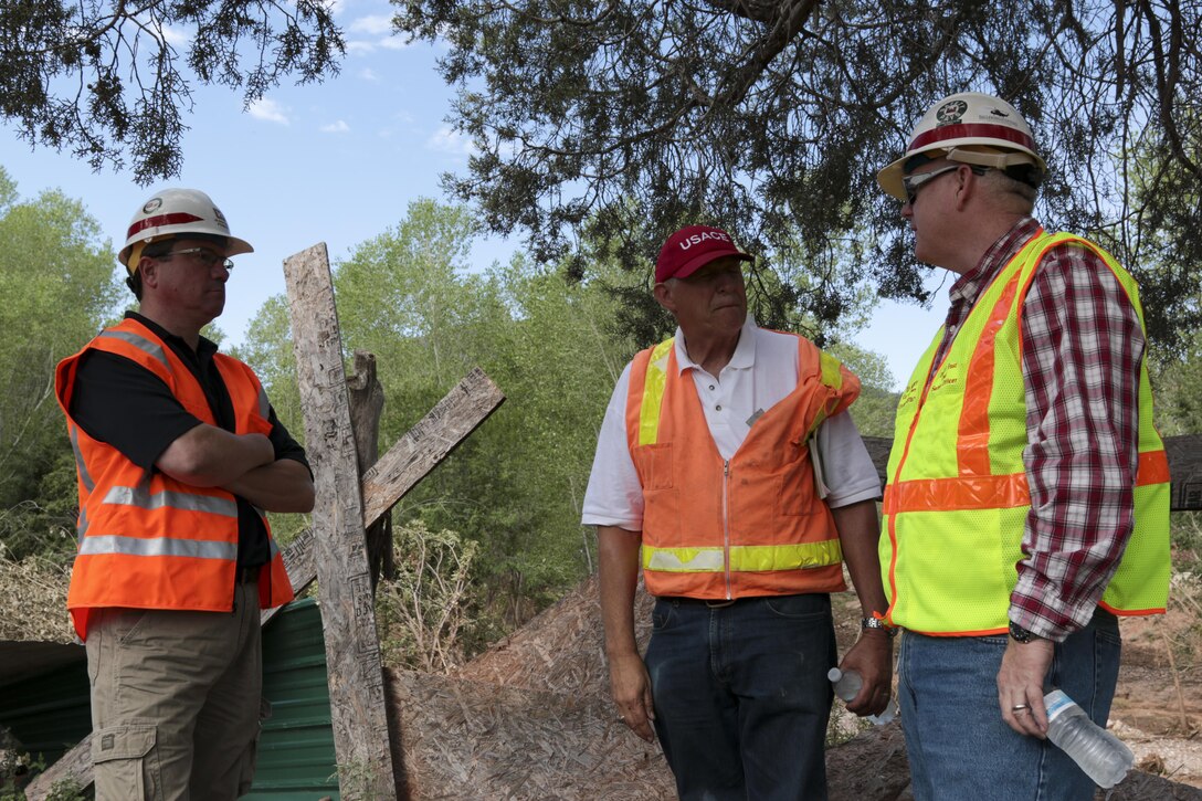 U.S. Army Corps of Engineers Los Angeles District employees Daryll Fust (right), safety chief, and Kim Gavigan (left), chief of the water resources planning section, tour the Cedar Creek, Arizona, project site Aug. 16. Jim Moye, senior construction representative, led the two on a survey of damage caused in an Aug. 11 storm event. The White Mountain Apache Tribe requested emergency assistance from the Corps to meet the immediate flood risk. The Corps is authorized under Public Law 84-99 to undertake emergency operations and provide flood fight assistance.
