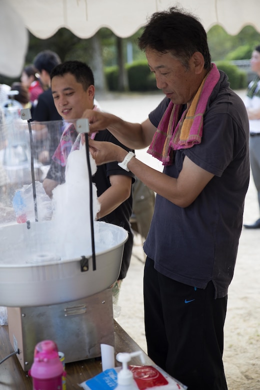 A Japanese local prepares cotton candy for guests attending the Bon-Odori Yukata-Experience festival in the Yokoyama area of Iwakuni, Japan, Aug. 13, 2016. The festival consisted of refreshments, snacks, dancing and honoring those who passed. (U.S. Marine Corps photo by Lance Cpl. Joseph Abrego)