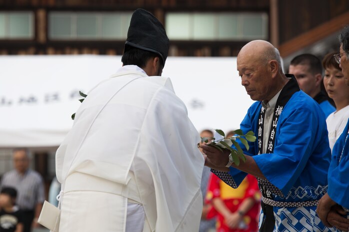 Masatoshi Ohno, Yokoyama 1st section representative and Iwakuni local, prepares to honor the Shiroyama Hime Shrine during the Bon-Odori Yukata-Experience festival in the Yokoyama area of Iwakuni, Japan, Aug. 13, 2016. During the festival, priests blessed the Shiroyama Hime shrine and gave a moment of silence in honor of those who passed this year. (U.S. Marine Corps photo by Lance Cpl. Joseph Abrego)