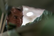 U.S. Air Force Senior Airman Andrew Fox, 36th Airlift Squadron joint airdrop inspector, inspects the parachute on a container delivery system bundle during Red Flag Alaska on Joint Base Elmendorf-Richardson, Alaska, Aug. 11, 2016. To prevent and lower the risk of malfunctions during drops JAI’s inspect bundles for proper rigging, packaging and sign of worn or weathered material that may cause problems. (U.S. Air Force photo by Staff Sgt. Michael Smith/Released)
