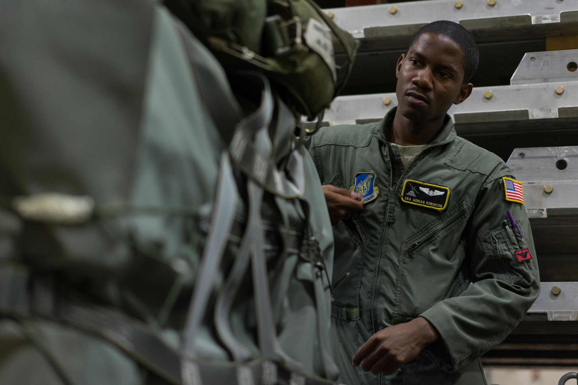 U.S. Air Force Senior Airman Adrian Robinson, 36th Airlift Squadron joint airdrop inspector, inspects the rigging on a container delivery system bundle during Red Flag Alaska on Joint Base Elmendorf-Richardson, Alaska, Aug. 11, 2016. Bundles that are improperly rigged can lead to malfunctions which hold the risk of damaging aircraft, personnel and can lead to mission failure. (U.S. Air Force photo by Staff Sgt. Michael Smith/Released)