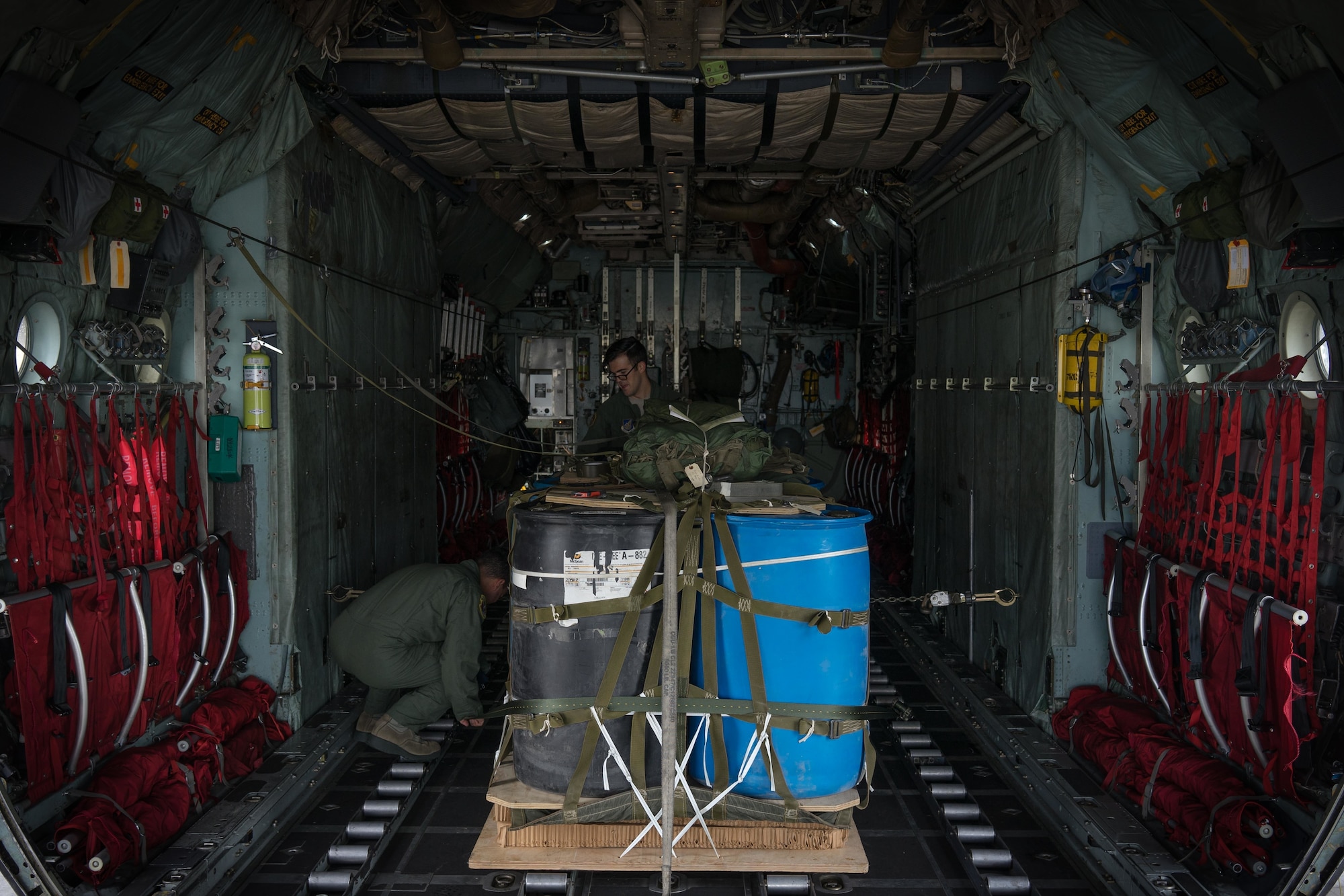 U.S. Air Force Senior Airman Angel Torres and Senior Airman Joel Eicher, 36th Airlift Squadron loadmasters, rig container delivery system bundles onto A C-130 Hercules during Red Flag Alaska on Joint Base Elmendorf-Richardson, Alaska, Aug. 12, 2016. The 36 AS uses pallets such as these to simulate airdrop procedures for supplies. (U.S. Air Force photo by Staff Sgt. Michael Smith/Released)