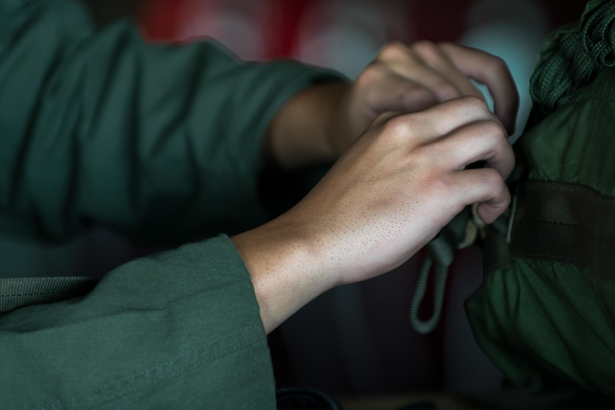 U.S. Air Force Senior Airman Angel Torres, 36th Airlift Squadron loadmaster, goes through rigging procedures for a container delivery system bundle during Red Flag Alaska on Joint Base Elmendorf-Richardson, Alaska, Aug. 12, 2016. Instead of being pushed out of the plane by a loadmaster, cds bundles are ejected using only the forward momentum of the aircraft. (U.S. Air Force photo by Staff Sgt. Michael Smith/Released)