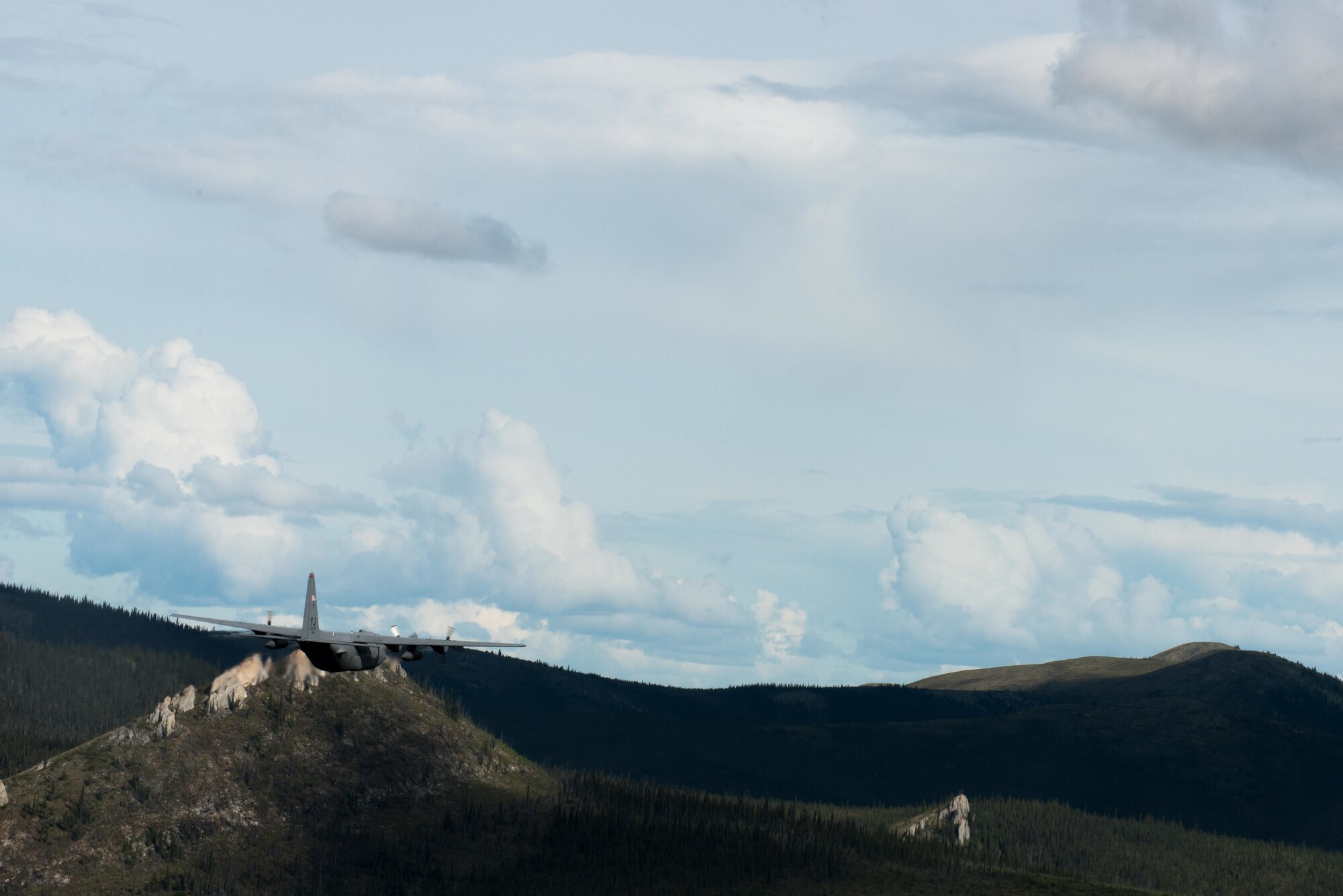 A C-130 Hercules from Yokota Air Base flies over a training during Red Flag Alaska near Joint Base Elmendorf-Richardson, Alaska, Aug. 12, 2016. While flying over the training range the aircrew’s objective is to avoid being targeted by ground and aerial weapon systems. (U.S. Air Force photo by Staff Sgt. Michael Smith/Released)