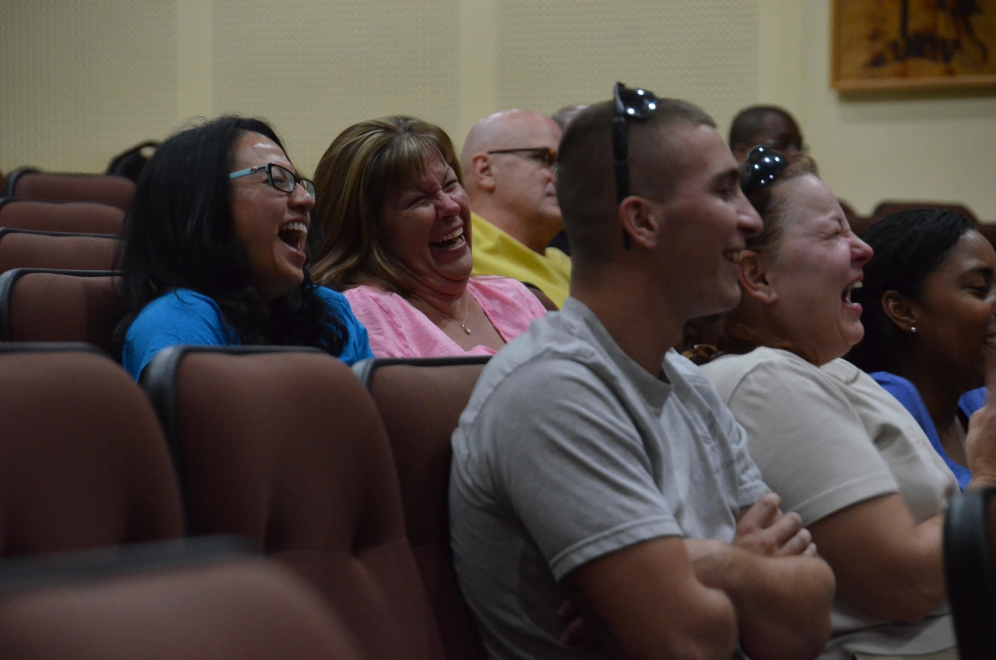 Airmen of the Rock laugh during the Tommy Davidson performance at the base theater, Aug. 13. (US Air Force photo/Master Sgt. Andrew Biscoe)