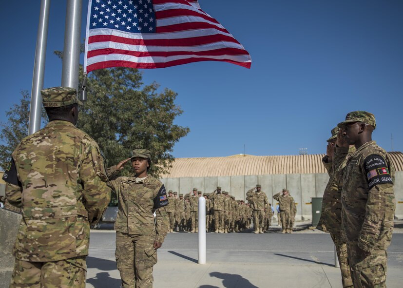 Members of the 455th Air Expeditionary Wing Honor Guard, salute the flag as it is lowered during a retreat ceremony, Bagram Airfield, Afghanistan, Aug. 15, 2016. Retreat ceremonies are held to signal the end of the official duty day and serves as a ceremony for paying respect to the flag. (U.S. Air Force photo by Senior Airman Justyn M. Freeman)
