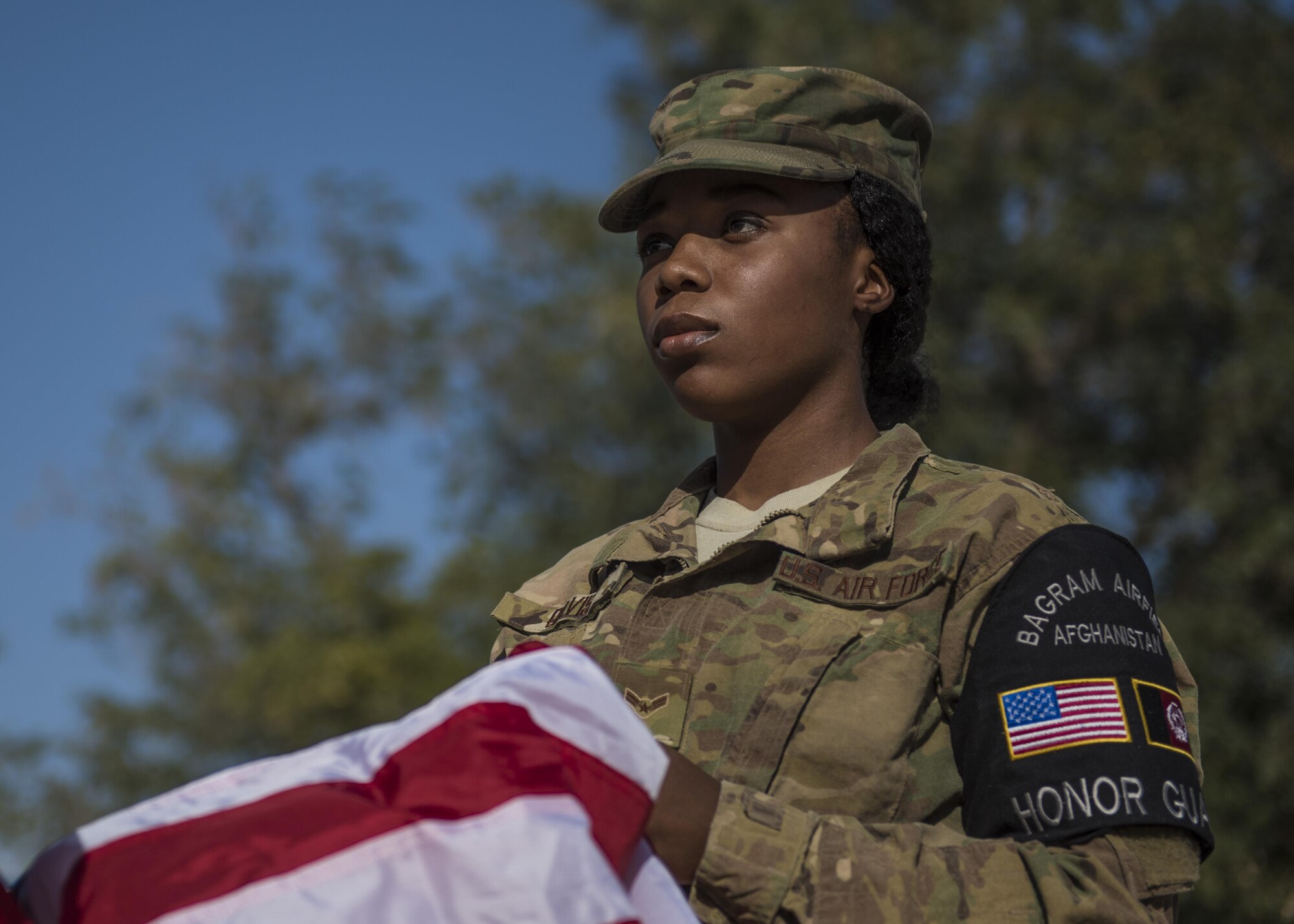Airman 1st Class Taylor Davis, 455th Air Expeditionary Wing Honor Guard member, folds a flag during a retreat ceremony, Bagram Airfield, Afghanistan, Aug. 15, 2016. Base honor guard is made up of volunteers who are dedicated to preserving the Air Force heritage and promote and protect the Air Force image and standards. (U.S. Air Force photo by Senior Airman Justyn M. Freeman)