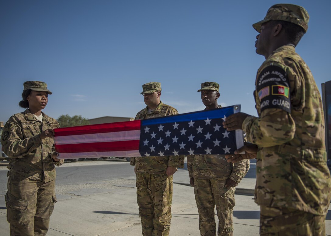 Members of the 455th Air Expeditionary Wing Honor Guard, fold a flag during a retreat ceremony, Bagram Airfield, Afghanistan, Aug. 15, 2016. Base honor guard is made up of volunteers who perform military honors at official ceremonies such as retreat ceremonies, change of commands, and special observances. (U.S. Air Force photo by Senior Airman Justyn M. Freeman)