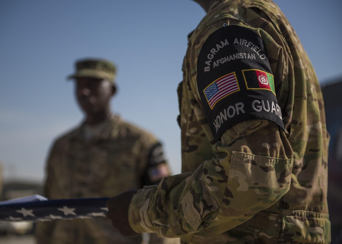 Members of the 455th Air Expeditionary Wing Honor Guard, fold a flag during a retreat ceremony, Bagram Airfield, Afghanistan, Aug. 15, 2016. Base honor guard is made up of volunteers who are dedicated to preserving Air Force heritage and promote and protect the Air Force image and standards. (U.S. Air Force photo by Senior Airman Justyn M. Freeman)