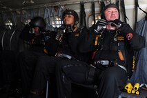 Member's of the U.S. Army Golden Knights prepare to jump out of a plane at the Northern Neighbors Day Air Show at Minot Air Force Base, N.D., Aug. 13, 2016. The team performs parachute demonstrations at air shows, major league football and baseball games, and other special events, connecting the Army with the American people. (U.S. Air Force photo/Senior Airman Kristoffer Kaubisch)