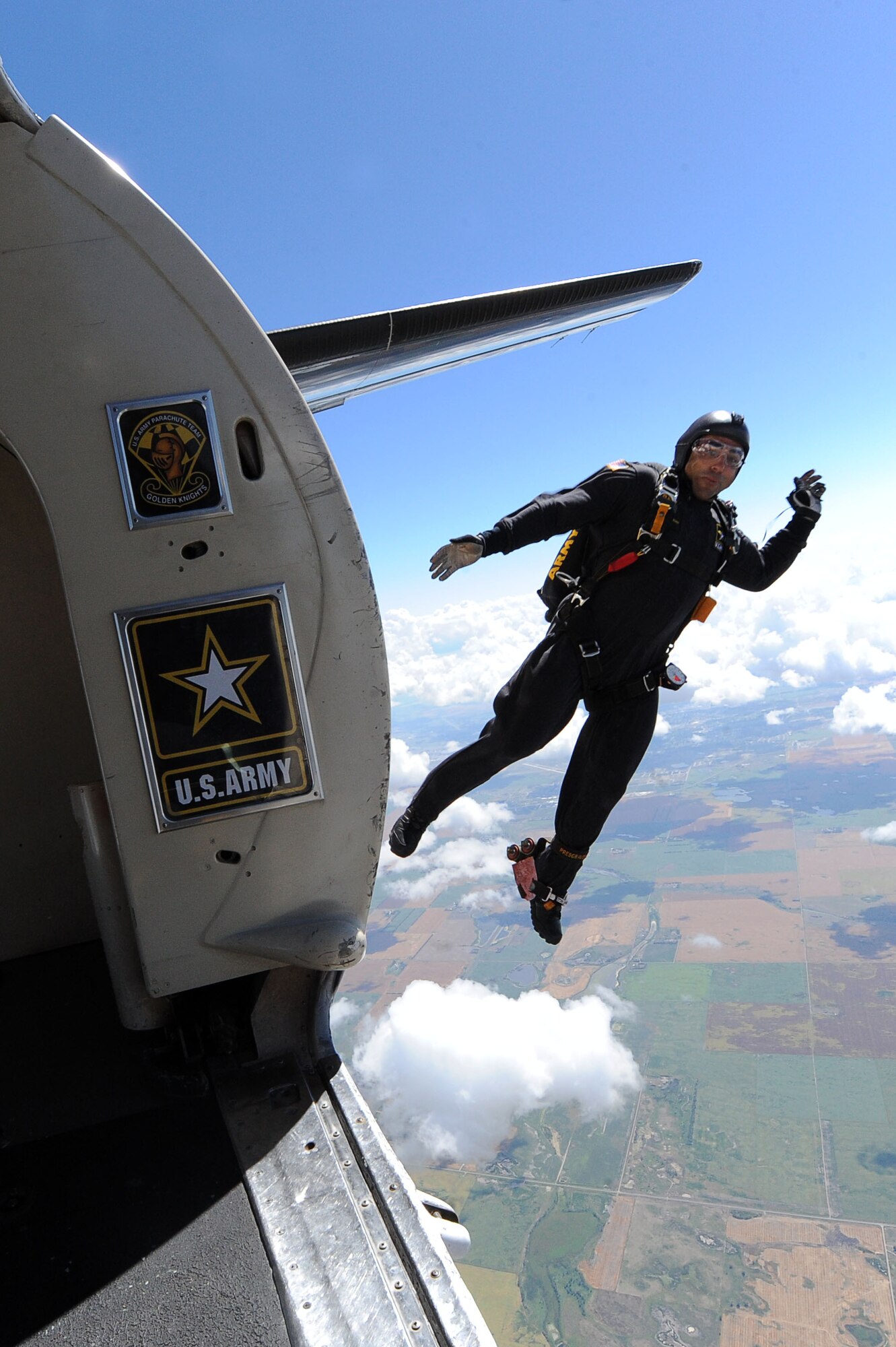 A member of the U.S. Army Golden Knights jumps out of a plane at the Northern Neighbors Day Air Show at Minot Air Force Base, N.D., Aug. 13, 2016. The team performs parachute demonstrations at air shows, major league football and baseball games, and other special events, connecting the Army with the American people. (U.S. Air Force photo/Senior Airman Kristoffer Kaubisch)