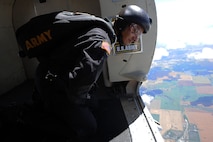 A member of the U.S. Army Golden Knights looks out over the Northern Neighbors Day Air Show at Minot Air Force Base, N.D., Aug. 13, 2016. The team performs parachute demonstrations at air shows, major league football and baseball games, and other special events, connecting the Army with the American people. (U.S. Air Force photo/Senior Airman Kristoffer Kaubisch)