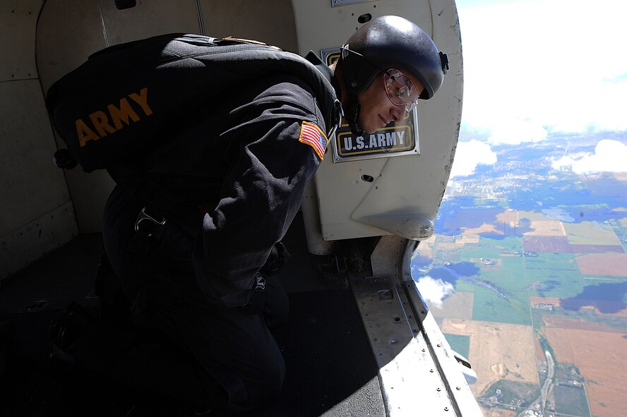 A member of the U.S. Army Golden Knights looks out over the Northern Neighbors Day Air Show at Minot Air Force Base, N.D., Aug. 13, 2016. The team performs parachute demonstrations at air shows, major league football and baseball games, and other special events, connecting the Army with the American people. (U.S. Air Force photo/Senior Airman Kristoffer Kaubisch)