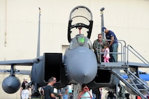 A little girl and her father observe an F-15 Strike Eagle static display at the Northern Neighbors Day Air Show at Minot Air Force Base, N.D., Aug. 13, 2016. Other static displays at the air show included a B-1 Bomber, UH-1N Huey, A-10 Warthog, C-130 Hercules and many more aircraft. (U.S. Air Force photo/Senior Airman Kristoffer Kaubisch)