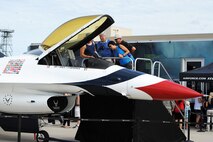 Spectators observe a Thunderbird F-16 Fighting Falcon static display at the Northern Neighbors Day Air Show at Minot Air Force Base, N.D., Aug. 13, 2016. Other static displays at the air show included a B-1 Bomber, UH-1N Huey, A-10 Warthog, C-130 Hercules and many more aircraft. (U.S. Air Force photo/Senior Airman Kristoffer Kaubisch)