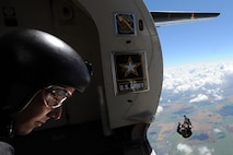 A member of the U.S. Army Golden Knights jumps out of a plane as another member watches the jump at the Northern Neighbors Day Air Show at Minot Air Force Base, N.D., Aug. 13, 2016. The team performs parachute demonstrations at air shows, major league football and baseball games, and other special events, connecting the Army with the American people. (U.S. Air Force photo/Senior Airman Kristoffer Kaubisch)