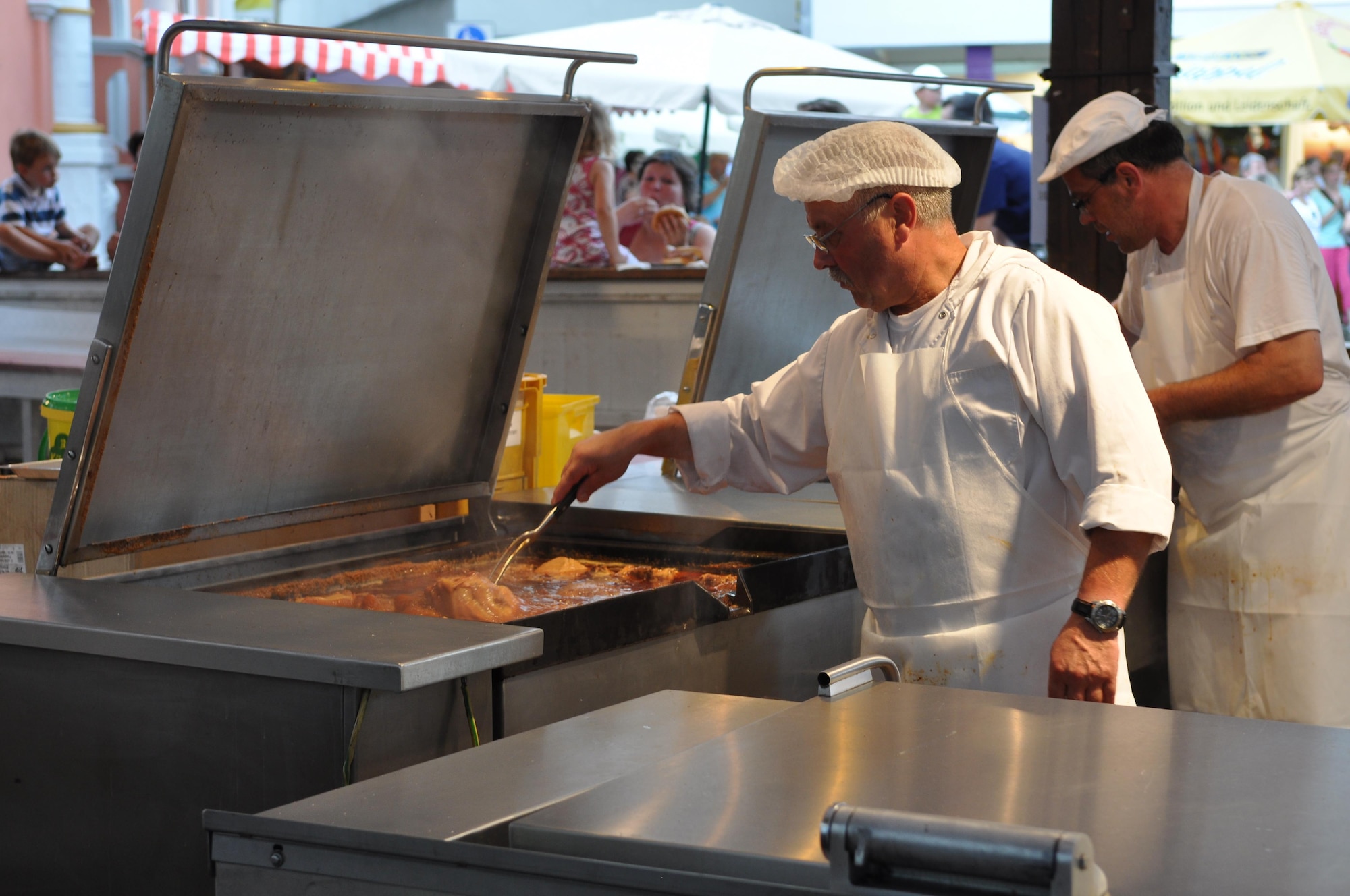 A cook prepares a roasting pig during the annual Pig Burner’s festival in Wittlich, Germany, Aug. 12, 2012. More than 200 pigs are sold annually at the popular "Saeubrenner Kirmes" in Wittlich, an event that attracts thousands of visitors from Germany and various other countries. (U.S. Air Force photo by Iris Reiff/Released)